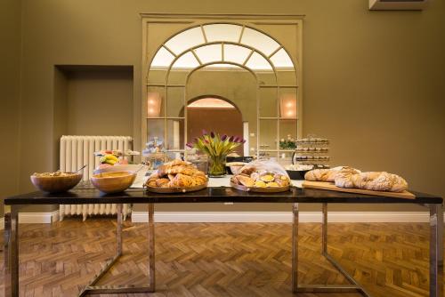 a table with bread and pastries on it at Forte16 View & SPA in Florence