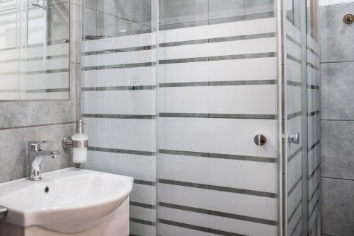 a bathroom with a sink and a shower at TOHOUSE Rooms in Turin