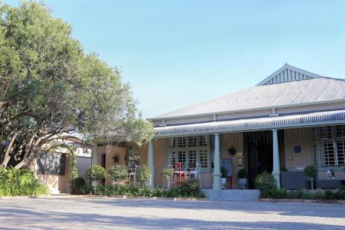 a building with a tree in front of it at Oleander Guest House in Kimberley