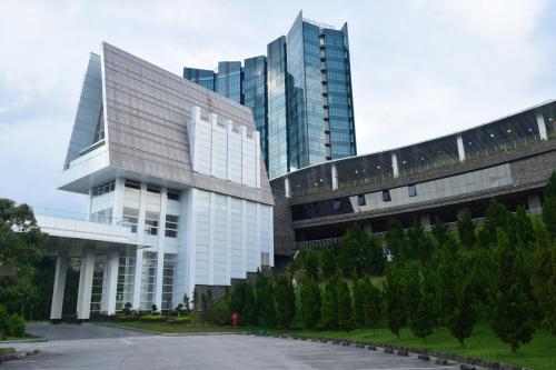a large office building with two tall buildings at Novotel Lampung in Bandar Lampung