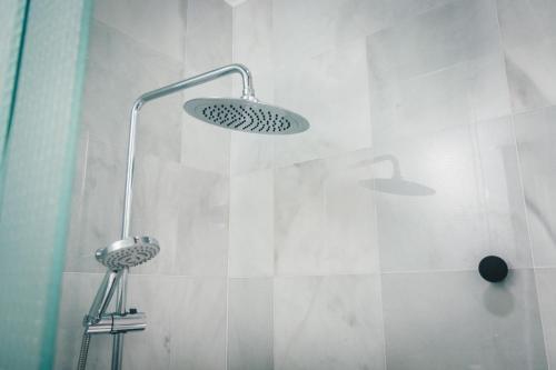 a shower with a shower head in a bathroom at Moyua Apartment by People Rentals in Bilbao