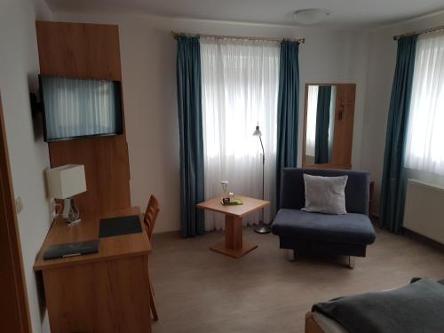 a living room with a couch and a chair at Gasthof Kolb in Bayreuth