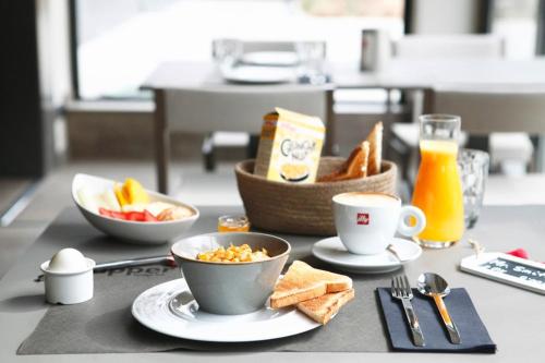 a table with cups and plates of food and toast at Upper Diagonal in Barcelona