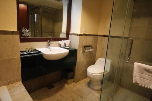 a bathroom with a sink and a toilet and a shower at Grand Riverview Hotel in Kota Bharu
