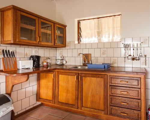a kitchen with wooden cabinets and a sink at Bay View Lodge in Miramar