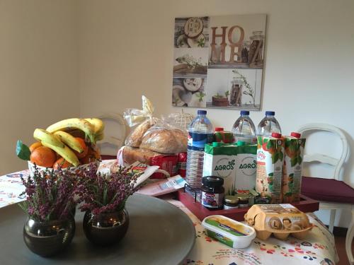 a table with food and bottles of water and flowers at Quinta do Cerqueiral in Arcos de Valdevez