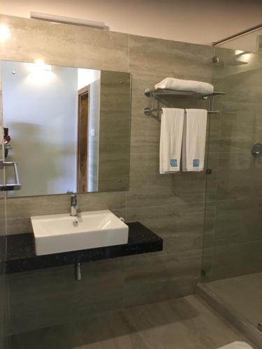 a bathroom with a sink and a mirror at Twenty-Two Weligambay in Weligama