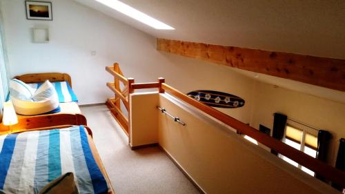 a room with two bunk beds and a staircase at Fewo Wellenreiter Usedom 200 m zum Strand mit Balkon Parkplatz Wlan in Ostseebad Karlshagen
