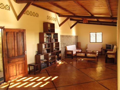 
a living room filled with furniture and a large window at La Case Sakalava in Ambaro
