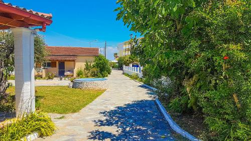 a walkway in a yard next to a house at Villa Panorea in Moraitika