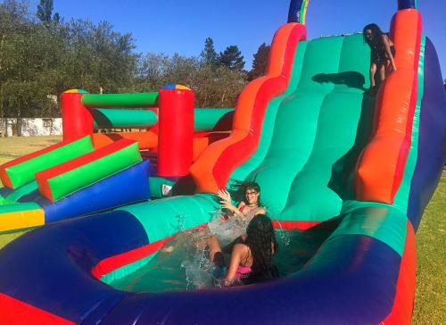 a group of children playing on a inflatable play structure at Houw Hoek Hotel in Botrivier