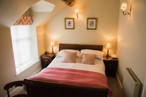 a bedroom with a large bed with two night stands at The Lion in Leintwardine