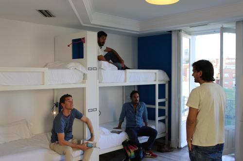 a group of men in a room with bunk beds at Safestay Madrid Central in Madrid