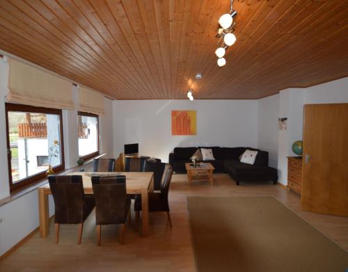a living room with a table and a couch at Gut Kallerbend in Nideggen