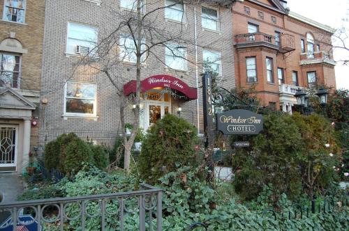 a brick building with a cafe sign in front of it at Windsor Inn Hotel in Washington