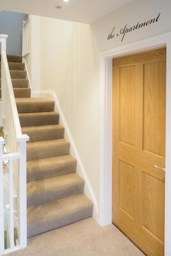 a staircase with a wooden door in a house at The Horngarth in Whitby
