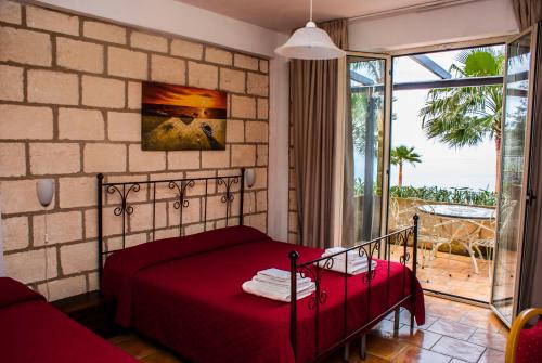 Postel nebo postele na pokoji v ubytování CapoSperone Resort