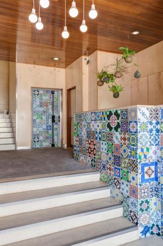 a lobby with tiles on the walls and stairs at AquaHotel in Ovar