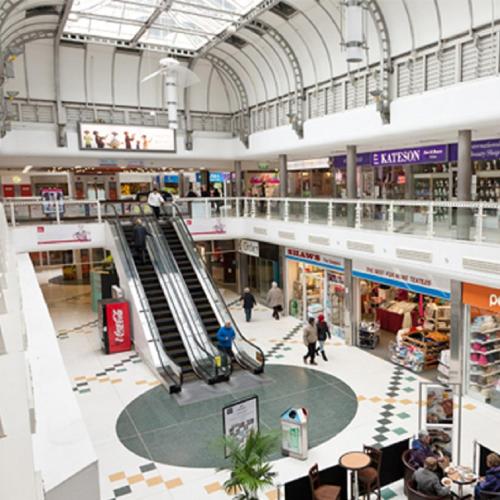 an empty shopping mall with an escalator in it at Swindon City Centre Duplex - EnterCloud9SA in Swindon