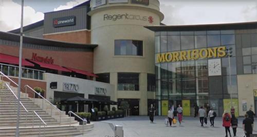a group of people walking in front of a building at Swindon City Centre Duplex - EnterCloud9SA in Swindon