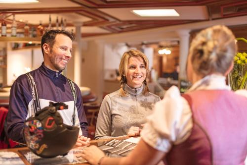 a group of people standing around a counter in a store at Hotel Andreas Hofer in Sankt Leonhard im Pitztal