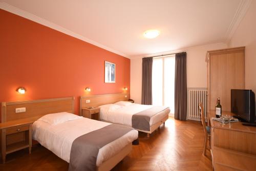 Postel nebo postele na pokoji v ubytování Hotel Sabot D'Or