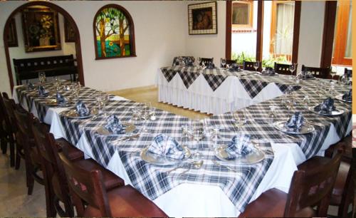 a long table with plates and dishes on it at Suites Colibri in Oaxaca City