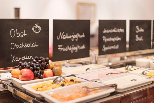 a buffet line with different types of fruits and vegetables at Hotel Andreas Hofer in Sankt Leonhard im Pitztal