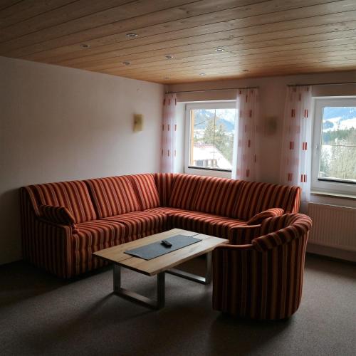 a living room with a couch and a coffee table at Hotel Bellevue in Riezlern