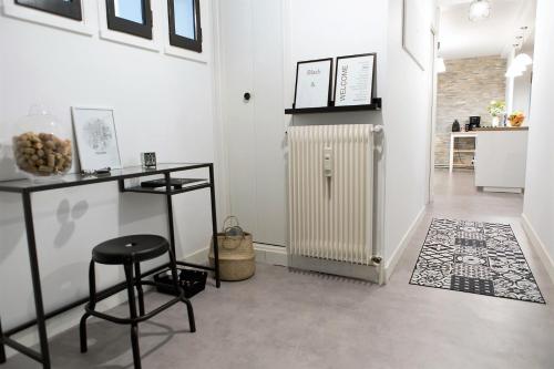 a room with a radiator and a table and stool at Gite Bons Amis in Dijon