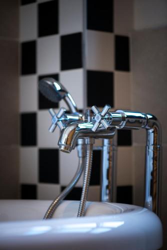 a bathroom sink with a chrome faucet at Mercure Belgrade Excelsior in Belgrade