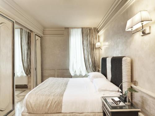 Postel nebo postele na pokoji v ubytování Hotel Barocco