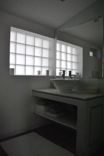 a bathroom with a sink and a large window at Maison l'Etrier in Saintes-Maries-de-la-Mer
