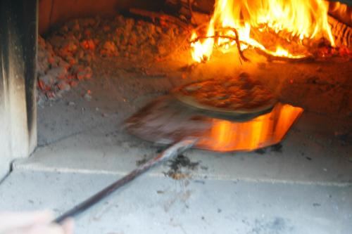 a pizza is being cooked in an oven at I Magnoni in Pergola