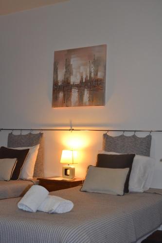 a bedroom with a bed with a painting on the wall at Central Suite in Funchal 2N in Funchal