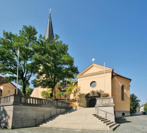 a church with stairs in front of a church at Hotel Biederstein am Englischen Garten in Munich