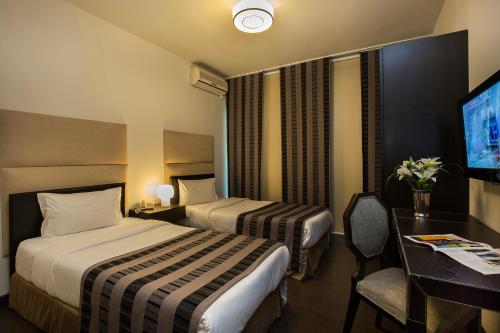 Katil atau katil-katil dalam bilik di Orient Queen Homes Hotel