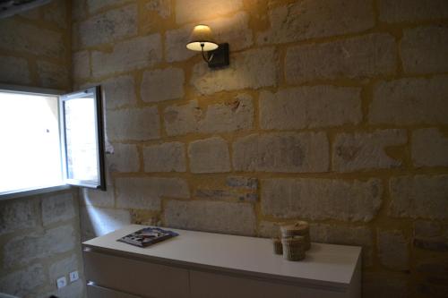 ユゼスにあるLa Pascallaneのレンガの壁のバスルーム(シンク付)