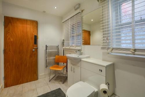 a white bathroom with a toilet and a sink at The LOCATION- 1 FREE PRIVATE PARKING SPACE - 60 SECOND WALK 2 MINSTER! in York