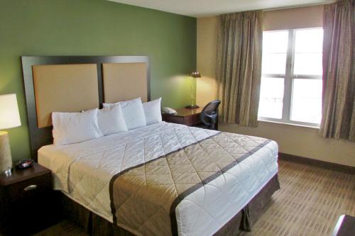 a hotel room with a large bed and a window at Extended Stay America Suites - Jacksonville - Deerwood Park in Jacksonville