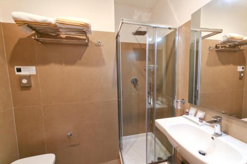 a bathroom with a shower and a sink and a toilet at 7th Floor Suite in Naples