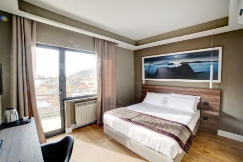 a bedroom with a bed and a large window at 7th Floor Suite in Naples