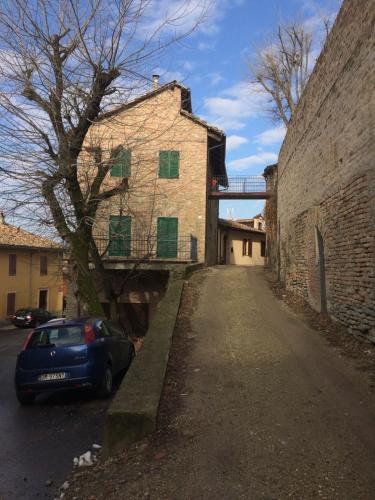 a blue car parked on the side of a street at Appartamento Riva in Neive