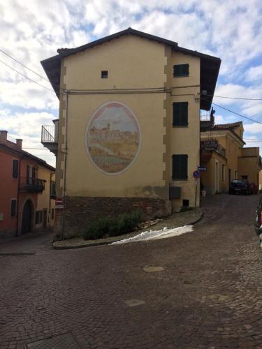 a building with a painting on the side of it at Appartamento Riva in Neive