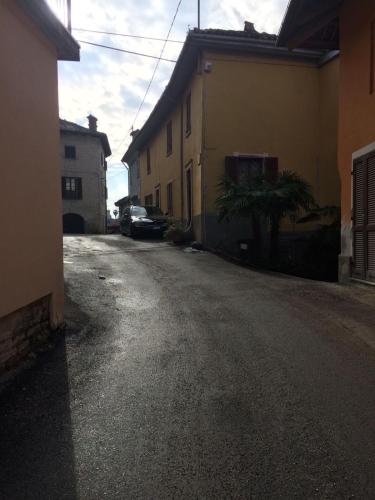 an empty street with a car parked next to a building at Appartamento Riva in Neive