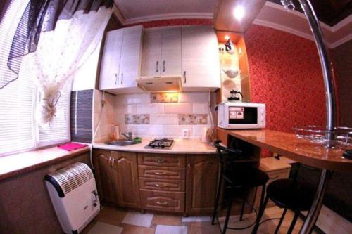 a small kitchen with a table and a counter top at Егорова in Kropyvnytskyi