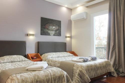 Postel nebo postele na pokoji v ubytování Hotel Lithaion