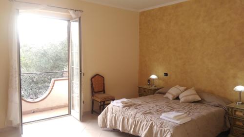 a bedroom with a bed and a sliding glass door at Edelweiss in Palmi