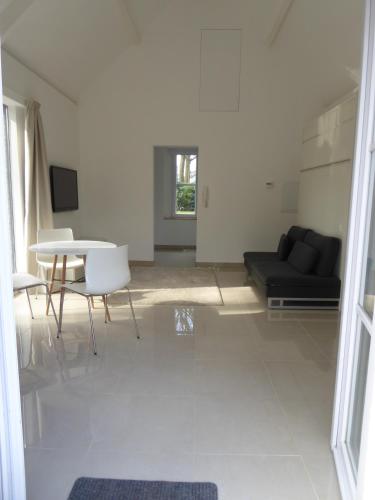 a living room with a couch and a table at B&B Goudvink in Schilde