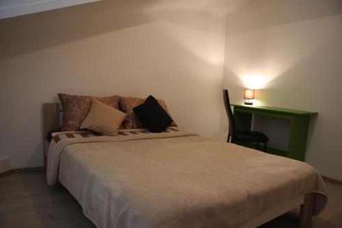 a bedroom with a bed and a green desk at Apartment in city center in Rijeka